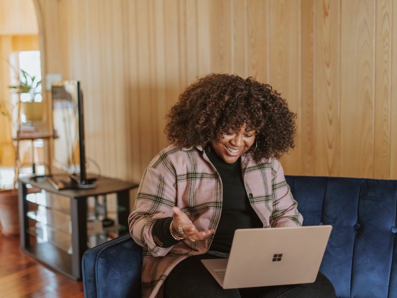 person sitting on couch holding a Surface device